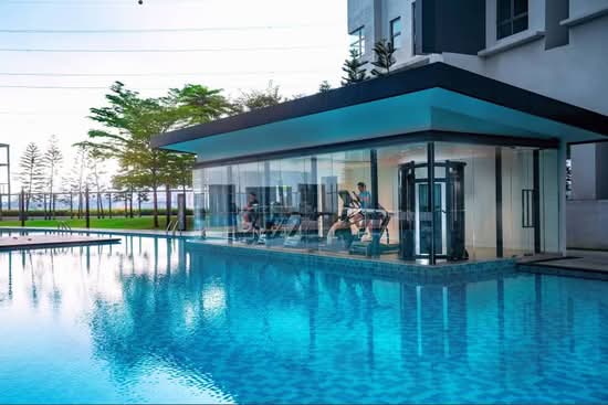D'Rapport Residences glass-encased gymnasium overlooking the pool at the former Drapport property